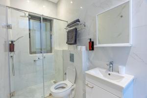 a bathroom with a toilet and a sink and a shower at Faya Nova- Appart hotel Central Stay in Casablanca +49 photos