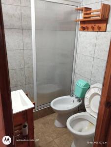een badkamer met een toilet, een wastafel en een douche bij Duplex Luz de Sol in Las Toninas