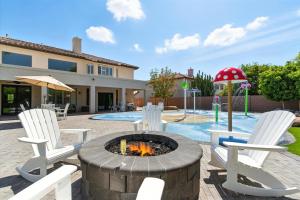 een patio met 2 stoelen en een vuurplaats bij Splash Canyon - Splash Pad & Tons of Games - Gym in Chandler