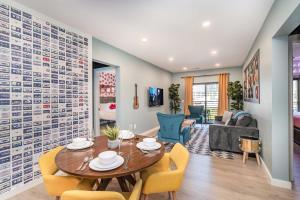a dining room and living room with a table and chairs at Hyve - Neon Lights - Pool & Gym - Walk to Broadway in Nashville