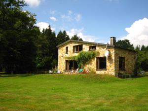 a stone house in a field of grass at Rustic Retreat in Houvegné in Houvegné