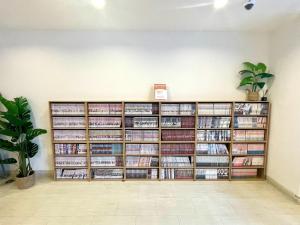a large book shelf filled with dvds at Miyazaki Mango Hotel - Vacation STAY 58298v in Miyazaki +17 photos