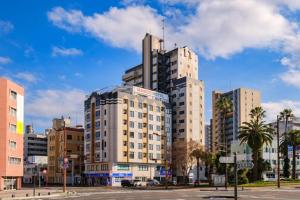 a city with tall buildings and palm trees at Miyazaki Mango Hotel - Vacation STAY 58298v in Miyazaki