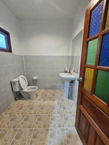 a bathroom with a toilet and a sink at ลันตาไวท์ร็อก รีสอร์ท in Ban Nong Chaeng