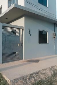 a white building with a garage door on it at Loft Marajó in Soure +6 photos