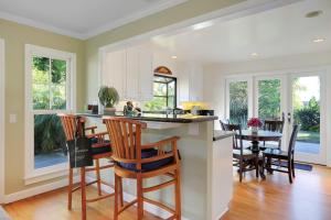 a kitchen and dining room with a table and chairs at Little Palm Cottage in Santa Barbara
