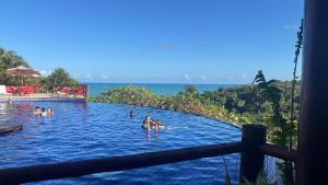 a group of people in the swimming pool at a resort at Villas Pratagy Flor de Lis 901-Studio in Maceió