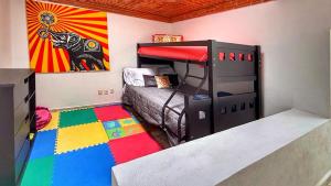a room with a bunk bed and a colorful rug at TX Golf Stay House with XL Jacuzzi and Soccer Field in Tequisquiapan +100 photos
