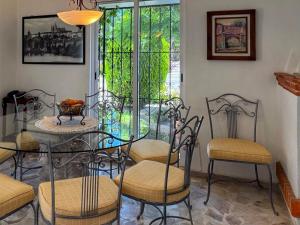 a dining room with a glass table and chairs at TX Golf Stay House with XL Jacuzzi and Soccer Field in Tequisquiapan