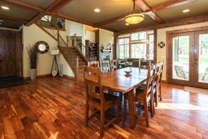 a dining room with a wooden table and chairs at Secluded Golf Course Retreat with Firepit, EV Charging, and Ultimate Privacy in Roslyn
