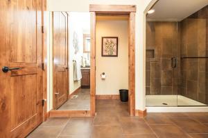 a bathroom with a walk in shower and a glass door at Secluded Golf Course Retreat with Firepit, EV Charging, and Ultimate Privacy in Roslyn +28 photos