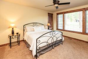 a bedroom with a bed and a ceiling fan at Secluded Golf Course Retreat with Firepit, EV Charging, and Ultimate Privacy in Roslyn