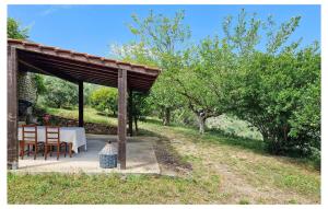 a table and chairs under a pavilion with trees at Stunning Home In Camporosso in Camporosso