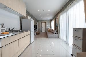 a kitchen with a refrigerator and a couch at Hale Twelve AB in Miyako-jima