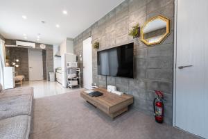 a living room with a flat screen tv on a wall at Hale Twelve AB in Miyako-jima +54 photos