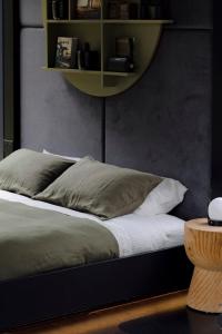 a bed with two pillows on it in a bedroom at The Lookout - a Huch experience in Wollombi