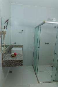 a bathroom with a glass shower with a sink at Hotel Karapitangui in Morro de São Paulo +25 photos