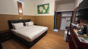 Ένα ή περισσότερα κρεβάτια σε δωμάτιο στο City Garden Bali Dwipa Hotel, Kuta