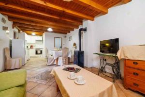 a living room with a table and a kitchen at Holiday home in Marusici - Istrien 39238 in Grižane