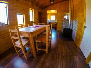 une salle à manger avec une table et des chaises en bois dans l'établissement Cabañas Aguapiedras, à Linares 8 autres photos