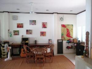 a room with a table and chairs and a desk at Nicolas Homestay Mekong Home in Pakse