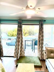 a living room with a couch and a large window at Cedar Key Islands Dolphins Cay Condo in Cedar Key +10 photos