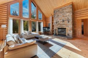 a living room with a couch and a fireplace at Fiddler Lake Resort - Deer 59 in Mille-Isles