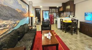 a living room and kitchen with a couch and a table at Sagarmatha Apartment Hotel in Pātan