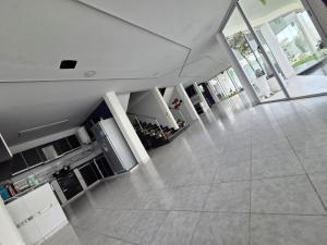 a large kitchen with white appliances in a building at Alisos Suite FC Torre 2 in El Ceibal