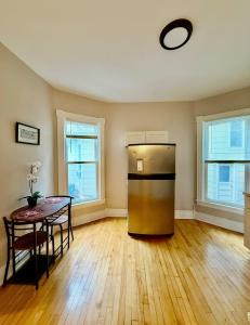 a kitchen with a stainless steel refrigerator and a table at Cozy 1bdrm,highfalls, Wi-fi, Dt, Shopping, Cozy in Rochester