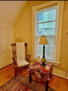 a living room with a chair and a table and a lamp at Cozy 1bdrm,highfalls, Wi-fi, Dt, Shopping, Cozy in Rochester +6 photos