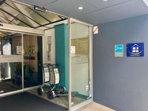 une pièce avec une porte vitrée avec un chariot à l'intérieur dans l'établissement Mercure Paris Porte d'Orleans, à Montrouge 106 autres photos