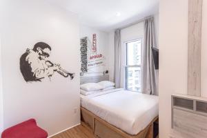 ニューヨークにあるJG Time Hotel by JGSTAY, Times Squareのベッドと窓のある小さな部屋 +23枚の写真