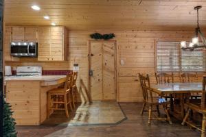 a kitchen and dining room with a table and chairs at Cabin 9- Spacious cabin- 4 King beds- 2 baths in Estes Park