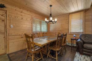 a dining room with a wooden table and chairs at Cabin 9- Spacious cabin- 4 King beds- 2 baths in Estes Park +24 photos