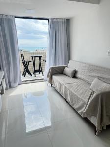 a bedroom with a bed and a large window at Cobertura Ponta Verde Vistar Mar in Maceió