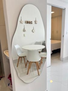 a white dining room with a white table and chairs at Cobertura Ponta Verde Vistar Mar in Maceió