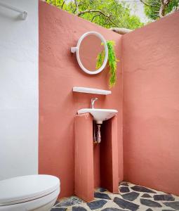 a bathroom with a sink and a mirror and a toilet at Lucky Resort in Ko Phayam