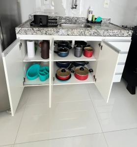a kitchen with a sink and a counter with pots and pans at Cobertura Ponta Verde Vistar Mar in Maceió