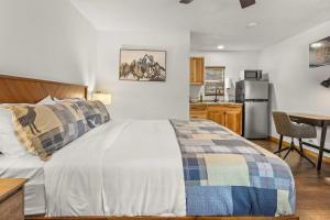 a bedroom with a bed and a desk and a kitchen at Cabin 14 - King Bed hotel-style unit in Estes Park