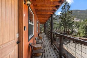a porch of a house with chairs on it at Cabin 14 - King Bed hotel-style unit in Estes Park