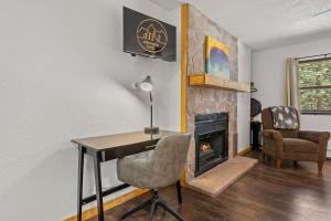 a room with a desk and a fireplace at Cabin 14 - King Bed hotel-style unit in Estes Park +19 photos