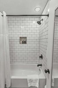 a white bathroom with a tub and a shower at Cabin15 - King bed Hotel Style Unit in Estes Park