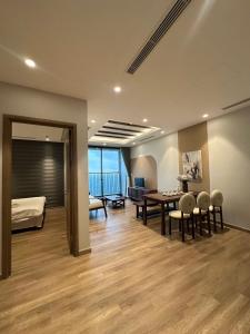 a room with a bed and a table and chairs at La paix home 3BR Lakefront Apartment with Balcony and Free Onsen in Kim Quan