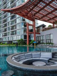 a swimming pool in front of a large building at La paix home 3BR Lakefront Apartment with Balcony and Free Onsen in Kim Quan