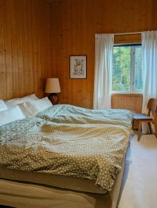 a bedroom with a large bed and a window at Cabin With Views Of The Oslofjord On Nesodden in Nordstrand