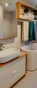 a bathroom with a tub and a sink and a bath tub at Cabin With Views Of The Oslofjord On Nesodden in Nordstrand