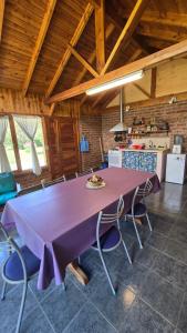 a large purple table in a kitchen with chairs at Casa Grande Trayken in El Hoyo