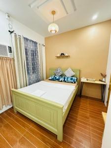 a bedroom with a large bed with blue pillows at The ComfyNook Hostel in Santa Maria