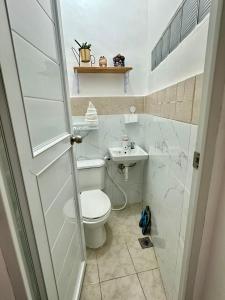 a bathroom with a toilet and a sink at The ComfyNook Hostel in Santa Maria +11 photos